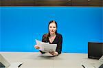 Businesswoman doing paperwork in a conference room