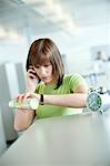 Businesswoman talking on a mobile phone and checking the time