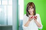 Businesswoman holding a bowl of cherry tomatoes