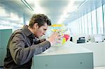 Businessman holding a globe and thinking in an office