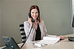 Businesswoman talking on a telephone in an office