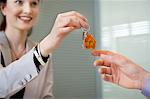 Female real estate agent giving house keys to a man