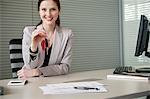 Female financial advisor holding a car key in an office