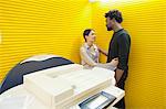 Business couple romancing near a photocopy machine
