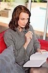 Young woman writing in notebook