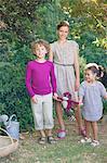 Portrait of cute little siblings standing in garden