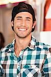 Close-up of a handsome man smiling at a cafe