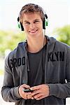 Man listening to music with headphones and smiling