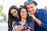 Three young people taking photo of themselves