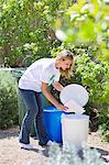 Woman throwing papers in garbage bin