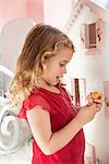 Cute little girl playing with a dollhouse