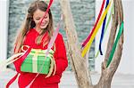 Girl holding a gift box and smiling