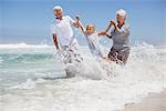 Girl enjoying on the beach with her grandparents