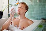 Man having bubble bath in a bathtub