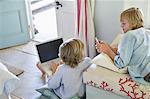 Children using electronic gadgets at home