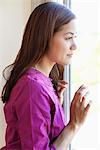 Profile of a young woman looking out of the window