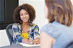 African American woman taking an interview of a woman