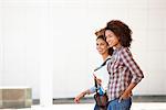 Two female friends walking in campus