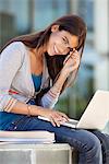 Portrait of a smiling woman using a laptop