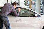 Mid adult man looking at car for buying