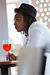 Young man having red wine at a bar