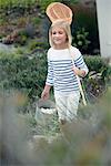 Girl carrying net and bucket for fishing