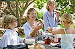 Family having food at front or back yard