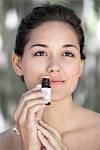 Young woman smelling aromatherapy oil