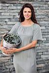 Woman holding a bucket of herbs