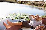 Young man sleeping in the boat