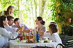 Multi generation family eating food at house