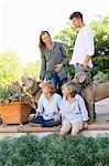 Family having a good time outside house with two dogs