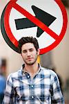 Handsome man smiling with no entry sign in the background