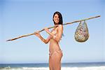 Young woman carrying net bag on shoulder