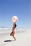 Woman playing with beach ball