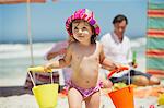 Cute girl carrying plastic basket