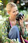 Smiling woman smelling eggplant