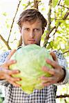 Portrait of a man holding a cabbage