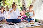 Children eating food in tree house