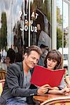 Couple reading menu at a restaurant, Paris, Ile-de-France, France