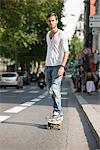 Man skateboarding on the road, Paris, Ile-de-France, France