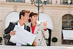 Couple reading a map, Paris, Ile-de-France, France