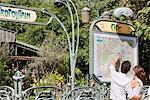 Couple pointing at a map, Paris, Ile-de-France, France