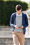 Man reading a travel guidebook, Paris, Ile-de-France, France