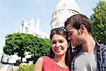 Man kissing a woman smiling, Montmartre, Paris, Ile-de-France, France
