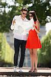 Couple reading a map in a garden, Terrasse De l'Orangerie, Jardin des Tuileries, Paris, Ile-de-France, France