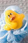 Rubber duck on mesh sponge, close-up