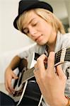 Teenage boy playing a guitar