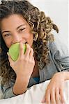 Girl eating an apple and smiling