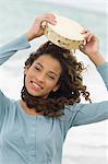 Portrait of a girl holding a tambourine over her head